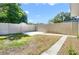 View of backyard with concrete walkway, privacy fence and blue skies at 2905 Elbert Way, Kissimmee, FL 34758