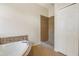 Bright bathroom featuring jetted tub, walk in shower, and tiled floors and walls at 2905 Elbert Way, Kissimmee, FL 34758