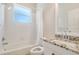 A well-lit bathroom features a shower-tub combo, and a modern vanity with a granite countertop at 2905 Elbert Way, Kissimmee, FL 34758