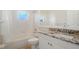 Bright bathroom featuring a shower and bathtub combo and a granite countertop vanity sink at 2905 Elbert Way, Kissimmee, FL 34758