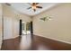 Spacious bedroom with hardwood floors, ceiling fan, sliding glass door and large window at 2905 Elbert Way, Kissimmee, FL 34758