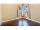 A well-lit bedroom featuring hardwood floors and a large window letting in lots of natural light at 2905 Elbert Way, Kissimmee, FL 34758