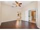 Bright bedroom offers hardwood floors, ceiling fan, and access to the ensuite bathroom and laundry room at 2905 Elbert Way, Kissimmee, FL 34758