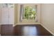 Bright bedroom featuring hardwood floors, large windows with backyard views, and natural light at 2905 Elbert Way, Kissimmee, FL 34758