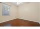 A cozy bedroom featuring hardwood floors, a ceiling fan and a window with natural light at 2905 Elbert Way, Kissimmee, FL 34758