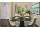 Cozy dining room featuring a round table, seating for four, and a sunlit window view at 2905 Elbert Way, Kissimmee, FL 34758