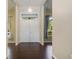 Bright foyer with hardwood floors, a decorative chandelier, and natural light, offering a warm welcome at 2905 Elbert Way, Kissimmee, FL 34758