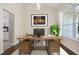 Home office with a large desk, natural light, and adjacent kitchen access at 2905 Elbert Way, Kissimmee, FL 34758