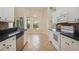 Well-lit kitchen with white cabinets, stainless steel appliances, and a breakfast nook with large windows at 2905 Elbert Way, Kissimmee, FL 34758