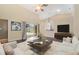 Cozy living room with stylish decor, including a modern coffee table, plush seating, and a media console, perfect for relaxing at 2905 Elbert Way, Kissimmee, FL 34758