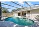 Inviting pool with screened enclosure, offering a serene outdoor living space for relaxation and recreation at 2905 Elbert Way, Kissimmee, FL 34758