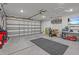 Spacious garage with ample room for storage, featuring a large sectional door and ample lighting at 2925 Sw 172Nd Lane Rd, Ocala, FL 34473