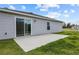 Back patio with sliding glass door and grassy yard at 2925 Sw 172Nd Lane Rd, Ocala, FL 34473