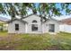 Backyard view of the home, with a well-manicured lawn and slider access to the home at 2978 Stillwater Dr, Kissimmee, FL 34743