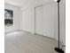 Bright bedroom featuring light wood flooring and a double door closet at 2978 Stillwater Dr, Kissimmee, FL 34743