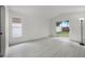 Bright bedroom with light wood flooring, a large window, and sliding glass doors leading to the backyard at 2978 Stillwater Dr, Kissimmee, FL 34743