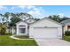 Charming single-Gathering home featuring a well-maintained lawn, two-car garage, and inviting front entrance at 2978 Stillwater Dr, Kissimmee, FL 34743