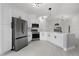 Bright kitchen featuring white cabinets, stainless steel appliances, and an island with seating at 2978 Stillwater Dr, Kissimmee, FL 34743
