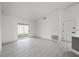 Open concept living room with sliding glass doors and light wood-look flooring at 2978 Stillwater Dr, Kissimmee, FL 34743