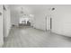 Open-concept space with light wood-look flooring and modern lighting fixtures at 2978 Stillwater Dr, Kissimmee, FL 34743