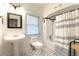 Bright bathroom with black and white tile flooring, pedestal sink, and shower-tub combo at 3 W Yale St, Orlando, FL 32804