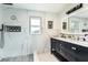 Stylish bathroom features marble walls, walk-in shower, and modern black vanity at 3 W Yale St, Orlando, FL 32804