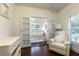Bright Bedroom features chair, white furniture, and view into another Bedroom at 3 W Yale St, Orlando, FL 32804