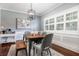 Dining room features a wooden table with seating, modern light fixture and view of the front yard at 3 W Yale St, Orlando, FL 32804
