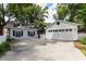 Home exterior features a detached garage, white picket fence, and well-maintained lawn at 3 W Yale St, Orlando, FL 32804