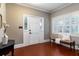 Bright foyer with terra cotta tile, shiplap walls, and a view of the charming front porch through shuttered windows at 3 W Yale St, Orlando, FL 32804
