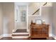 Hallway featuring wood floors, a wooden cabinet, a window with blind, and stairs to the second floor at 3 W Yale St, Orlando, FL 32804