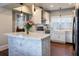 Bright kitchen featuring white cabinetry, a marble island, stainless appliances, and modern pendant lights at 3 W Yale St, Orlando, FL 32804