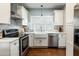 Bright kitchen features modern appliances, subway tile backsplash and a stainless steel range hood at 3 W Yale St, Orlando, FL 32804