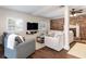 Cozy living room boasting a brick wall, fireplace, white sofas, and hardwood floors at 3 W Yale St, Orlando, FL 32804