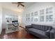 Bright office with a white desk, neutral colored sofa, and several windows with plantation shutters at 3 W Yale St, Orlando, FL 32804