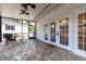 Screened patio with stone floors, ceiling fans, and view to the backyard at 3 W Yale St, Orlando, FL 32804