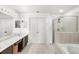 Spacious bathroom featuring dual sinks, a soaking tub, and a glass-enclosed shower at 3055 Ashland N Ln, Kissimmee, FL 34741