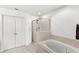 Bright bathroom showcases a tiled shower, relaxing soaking tub, and double-door closet at 3055 Ashland N Ln, Kissimmee, FL 34741