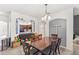 Dining room with a large wooden table, plush carpeting, and a partial view of the kitchen at 3055 Ashland N Ln, Kissimmee, FL 34741