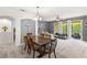 Open-concept dining area with a large dining table, gray walls and a sliding glass door to the exterior at 3055 Ashland N Ln, Kissimmee, FL 34741