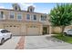 Exterior view of a townhouse with a two-car garage and well-maintained landscaping at 3055 Ashland N Ln, Kissimmee, FL 34741