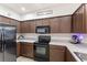 Functional kitchen with sleek black appliances, ample cabinet space, and a modern aesthetic at 3055 Ashland N Ln, Kissimmee, FL 34741