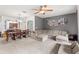 Open-concept living and dining area featuring comfortable seating and a ceiling fan at 3055 Ashland N Ln, Kissimmee, FL 34741