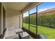 Screened patio with comfortable seating and views of the green backyard at 3055 Ashland N Ln, Kissimmee, FL 34741