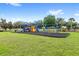 Community playground with swings, slides, and ample space for children to play at 3055 Ashland N Ln, Kissimmee, FL 34741