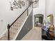 Elegant staircase with a combination of carpeted treads and tile flooring at 3055 Ashland N Ln, Kissimmee, FL 34741