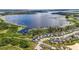Attractive aerial image highlighting a lakeside home near docks and lush greenery for peaceful waterfront living at 3404 Shallow Cove Ln, Clermont, FL 34711