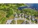 Overhead view of three homes with solar panels, docks, and waterside access at 3404 Shallow Cove Ln, Clermont, FL 34711