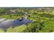 Picturesque aerial view featuring lakeside properties with docks and a tranquil waterfront setting surrounded by greenery at 3404 Shallow Cove Ln, Clermont, FL 34711
