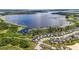 Stunning aerial view of lakeside homes with dock access and vibrant green landscape in a serene waterfront community at 3404 Shallow Cove Ln, Clermont, FL 34711